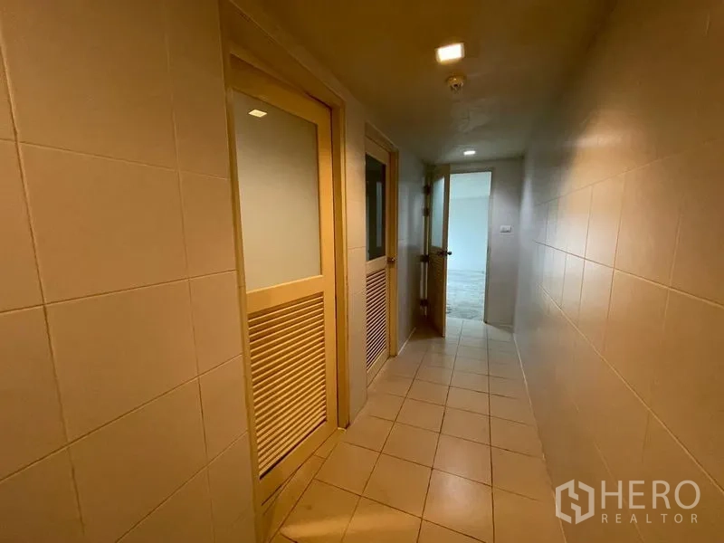 Office Space for rent in Ratchathewi, Bangkok - Tiled corridor with lighted ceiling leading to staff restrooms.