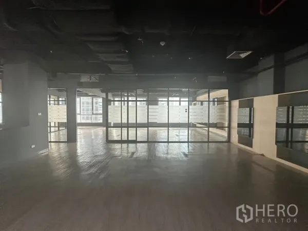 Office Space for rent in Bang Rak, Bangkok - Large open area with floor-to-ceiling glass partitions featuring frosted bands.
