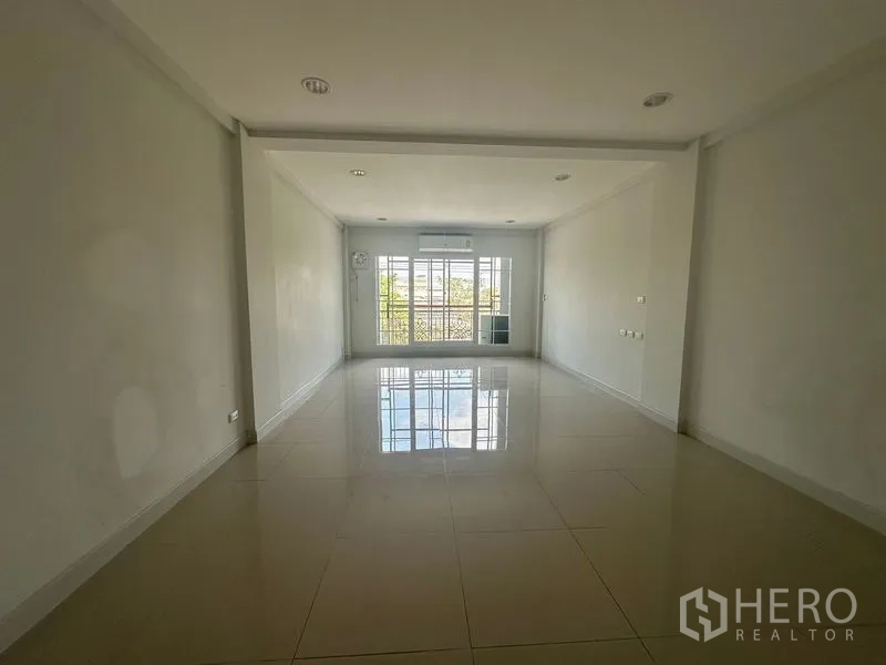 Home Office for rent in Bang Na, Bangkok - Bright workspace with large window, balcony door and wall-mounted air conditioner.
