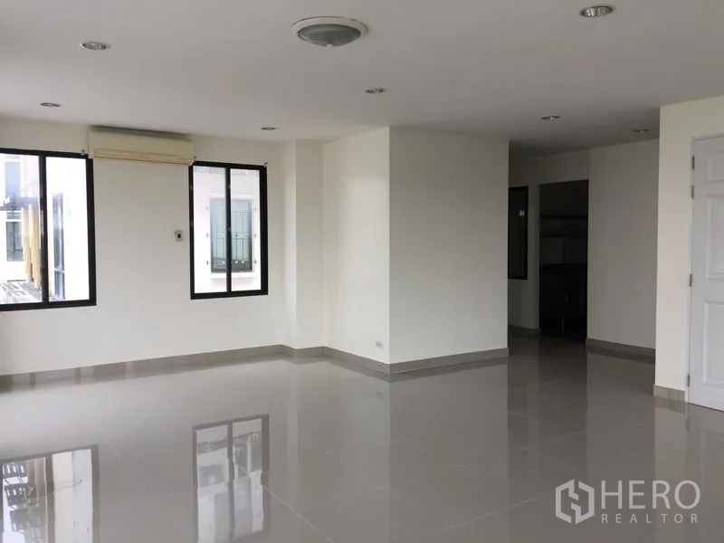 Office Space for rent in Bang Kho Laem, Bangkok - Upper-floor office room with multiple windows and a wall-mounted air conditioner.