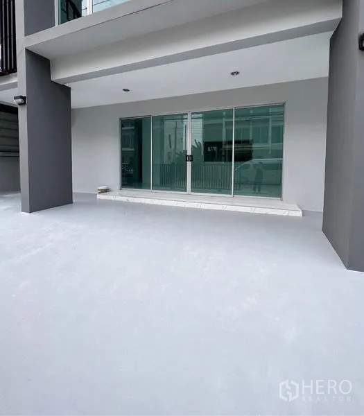 Home Office for sale in Lat Krabang, Bangkok - Sheltered ground-floor terrace with sliding glass doors leading into the office.
