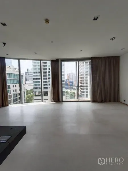 Condominium for rent or sale in Bang Rak, Bangkok - Bright living area with floor-to-ceiling windows, balcony access and Bangkok city views.