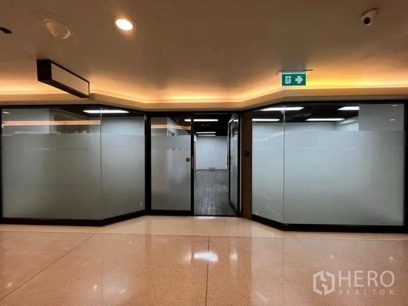 Office Space for rent in Khlong Toei, Bangkok - Exterior of office unit with wide frosted glass frontage and sliding door from building hallway.