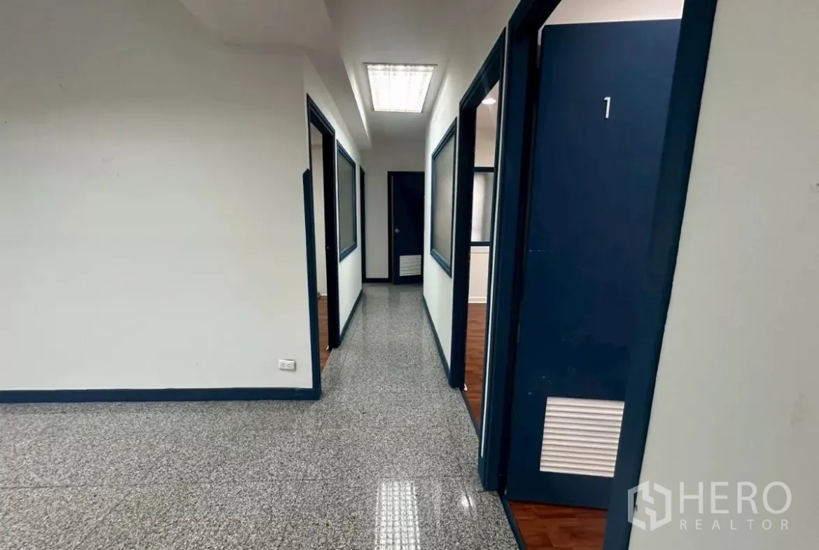 Office Space for rent in Khlong Toei, Bangkok - Corridor with numbered blue doors to multiple partitioned offices.