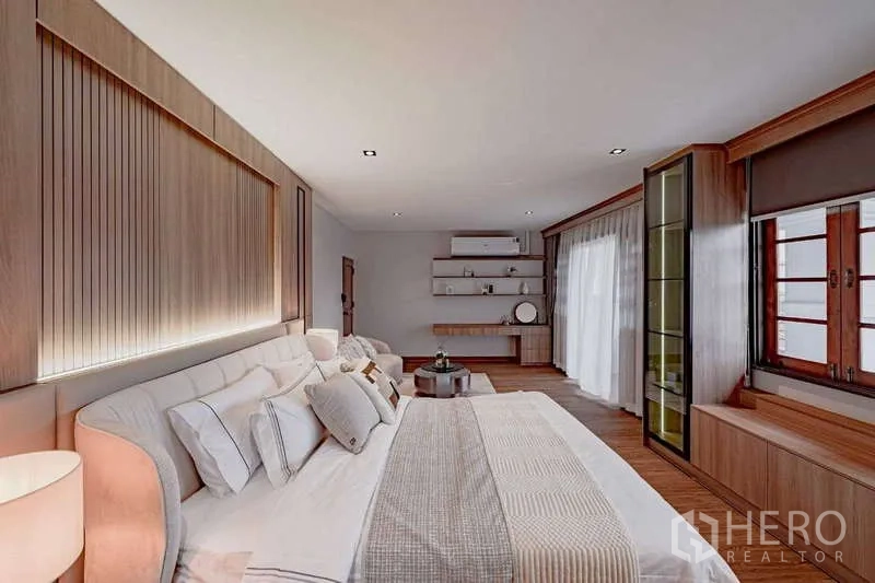 Detached House for rent or sale in Phra Khanong, Bangkok - Bedroom view with feature headboard, sofa seating, and wall-to-wall drapes.