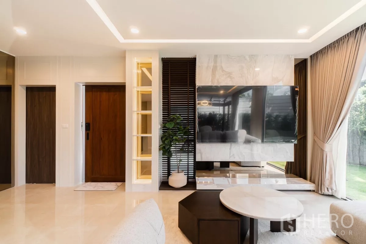 Detached House for rent or sale in Prawet, Bangkok - Entry area with wood door, illuminated shelving and TV feature wall