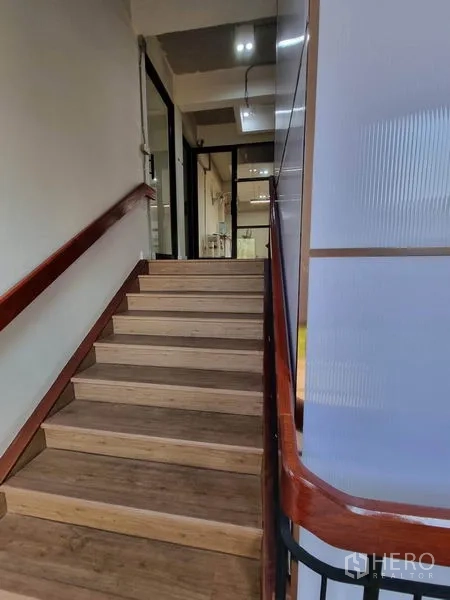Home Office for rent or sale in Phaya Thai, Bangkok - Interior staircase with wooden steps and handrail leading to upper office floors.