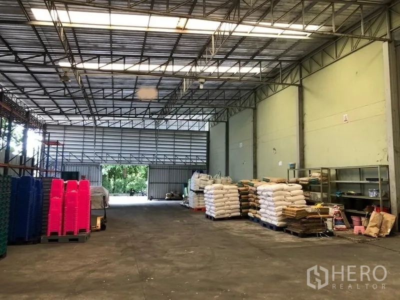 Factory for rent or sale in Khlong Luang, Pathum Thani - Secondary warehouse hall with large sliding doors and open floor space.