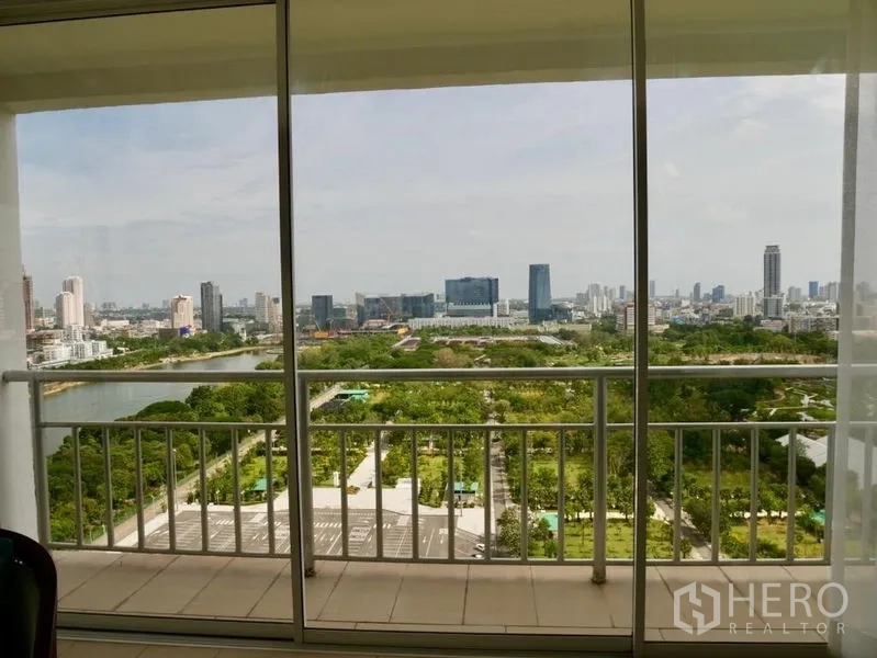 Condominium for rent in Khlong Toei, Bangkok - Balcony view overlooking Benjakitti Park’s lake and the Bangkok skyline.