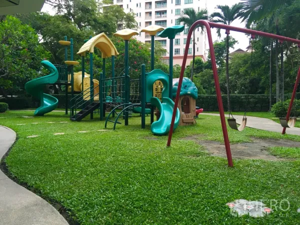 Condominium for rent or sale in Watthana, Bangkok - Lush garden playground with swings and slides for families.