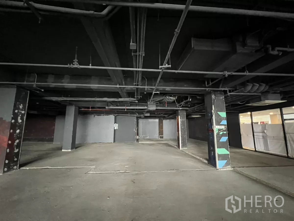 Retail Space for rent in Watthana, Bangkok - Spacious dark-finish unit with exposed ducts, columns, and open layout