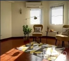Detached House for rent in Phra Khanong, Bangkok - Sunlit lounge corner with accent chairs, area rug and air conditioning.
