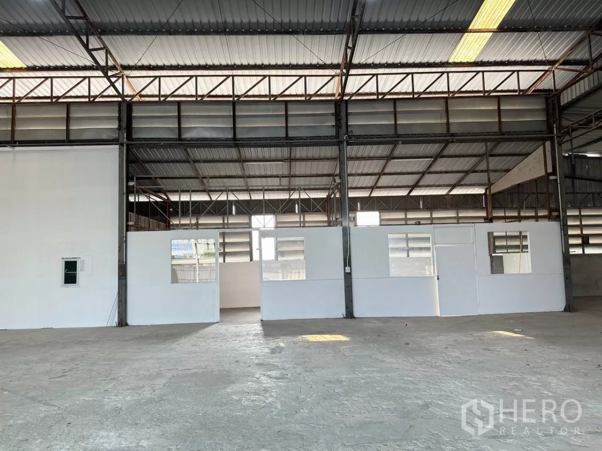 Factory for rent in Samut Prakan - Warehouse interior showing partitioned white office rooms.
