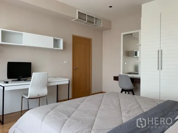 Condominium for rent in Khlong Toei, Bangkok - Bedroom corner featuring a work desk, door and built-in storage.