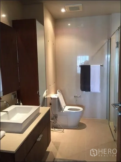 คอนโด ให้เช่าในWatthana, Bangkok - ห้องน้ำสมัยใหม่พร้อมอ่างล้างหน้า โถสุขภัณฑ์ และตู้กระจกอาบน้ำ