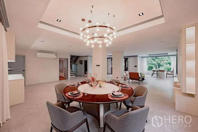 Detached House for rent or sale in Phra Khanong, Bangkok - Elegant dining room with a round table, chandelier, and open-plan layout.