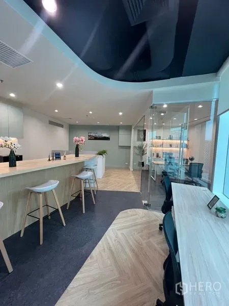 Office Space for rent - Open-plan office with long bar counter, workstations and glass private office.