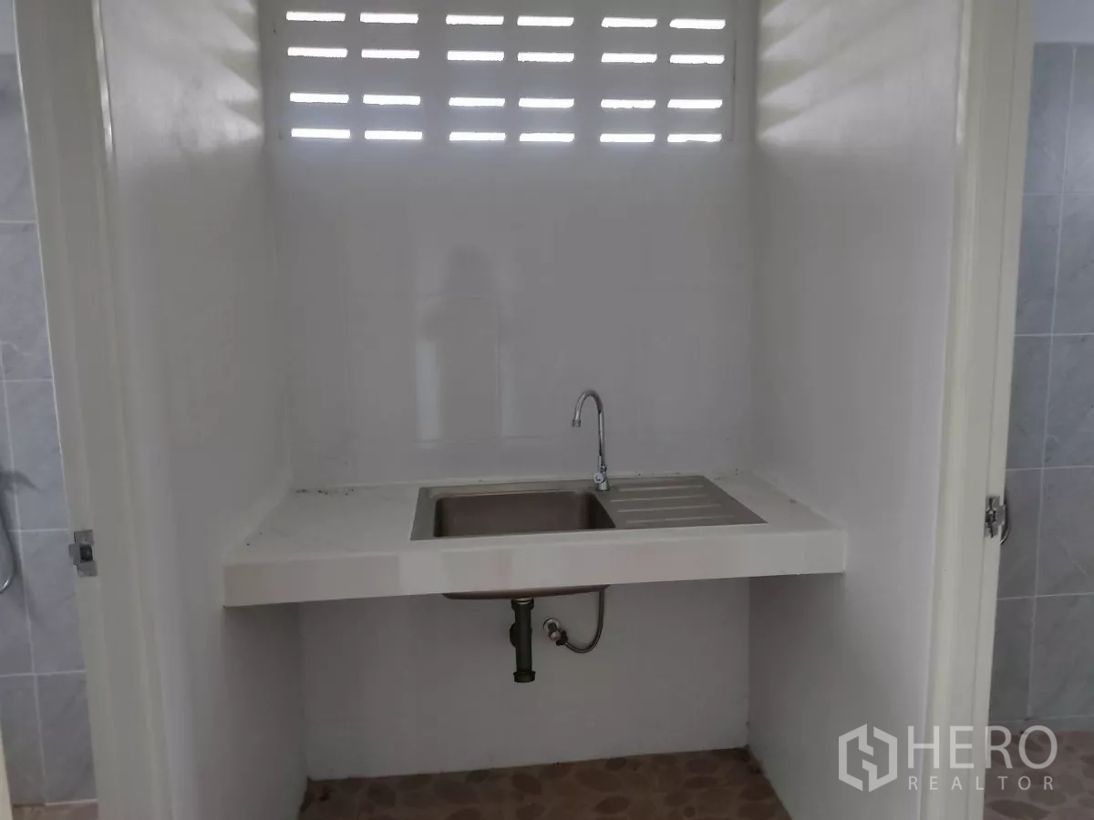 Factory for sale in Khlong Toei, Bangkok - Utility area with stainless sink and drainboard between rooms.