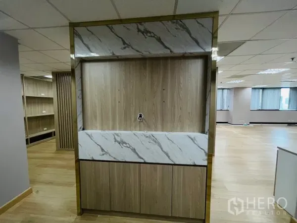 Office Space for rent - Built‑in reception or pantry cabinet with wood finish and marble accents inside the office.