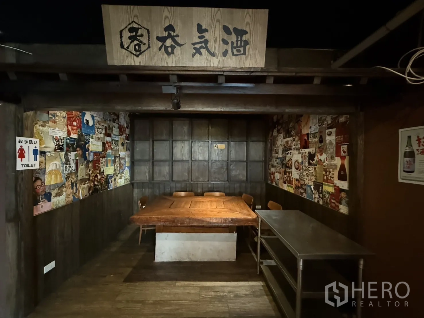 Detached House for rent in Watthana, Bangkok - Cozy booth-style dining nook with large wooden table and poster-lined walls.
