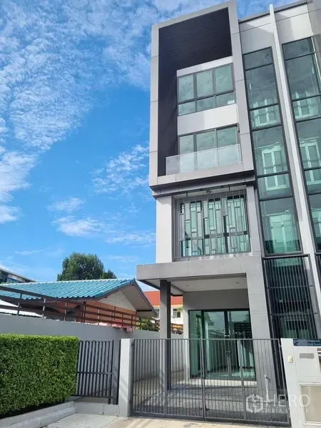 Home Office for rent in Don Mueang, Bangkok - Modern multi-storey home office exterior in Don Mueang, Bangkok with gated entry and tall glass windows.