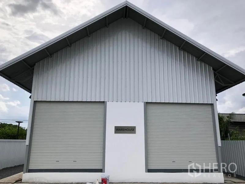 Warehouse for rent in Bueng Kum, Bangkok - Front elevation of metal-clad warehouse featuring two large roller shutter doors