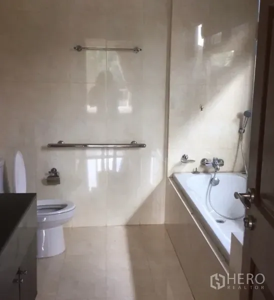 บ้าน ให้เช่าในBang Phli, Samut Prakan - ห้องน้ำปูกระเบื้องโทนครีม มีอ่างอาบน้ำ ฝักบัว และราวจับ