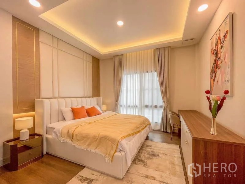 Detached House for rent in Saphan Sung, Bangkok - Stylish bedroom with cove lighting, padded headboard and large window.