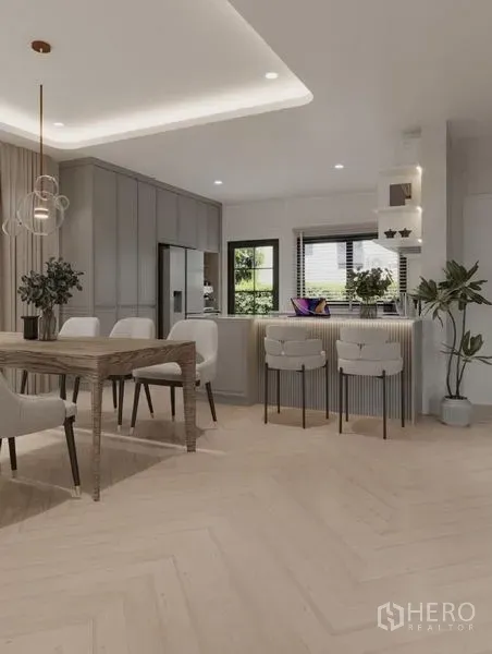 Detached House for rent in Bang Phli, Samut Prakan - Dining area with wood table for eight beside a breakfast bar and chevron floor.