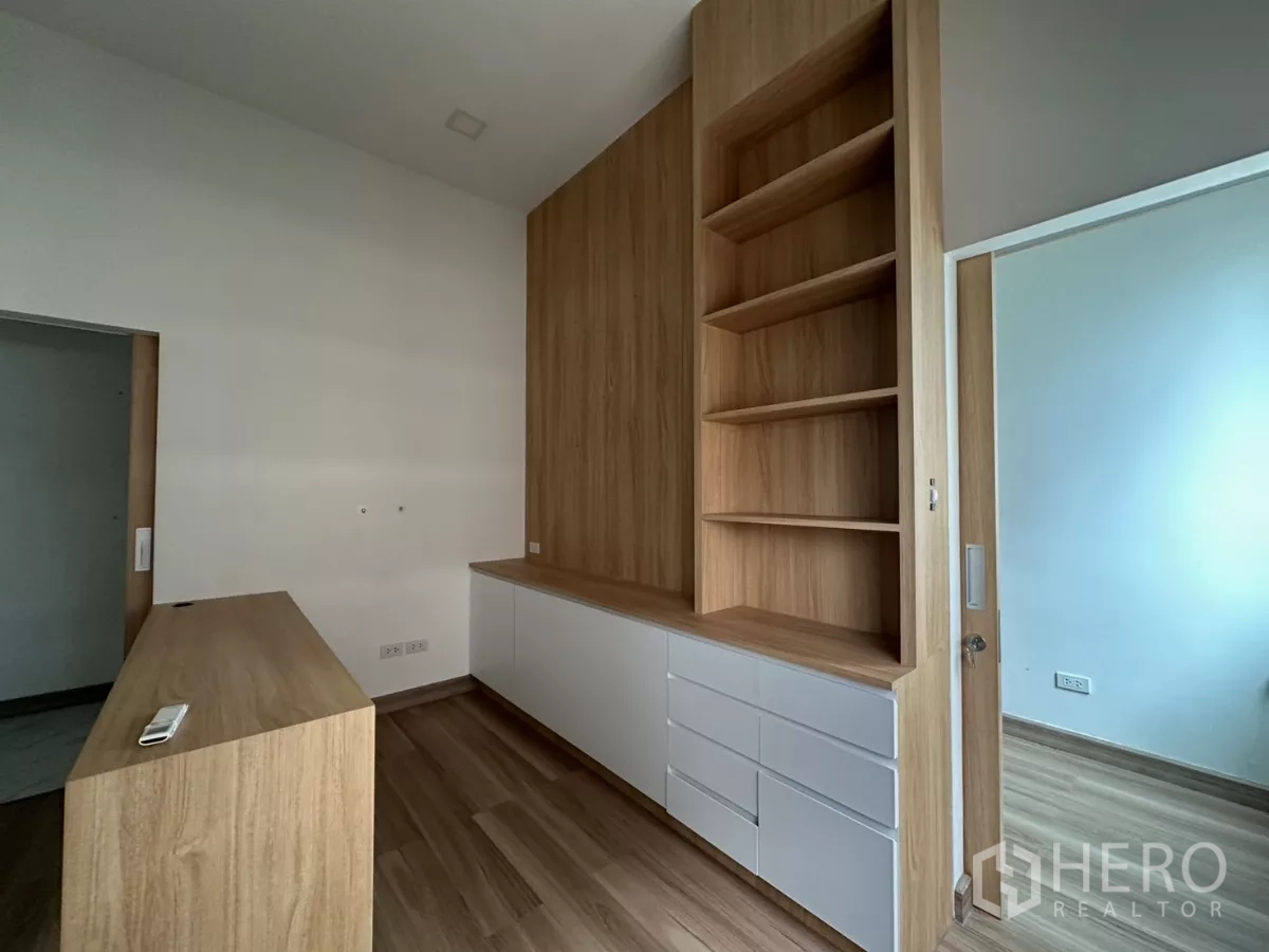 Retail Space for rent in Phra Khanong, Bangkok - Room with custom wood shelving, base cabinets and sliding door.
