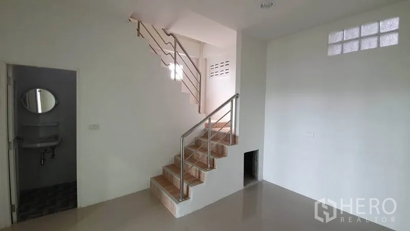 Warehouse for rent in Lam Luk Ka, Pathum Thani - Office stairwell with tiled steps, stainless handrail and access to a bathroom.
