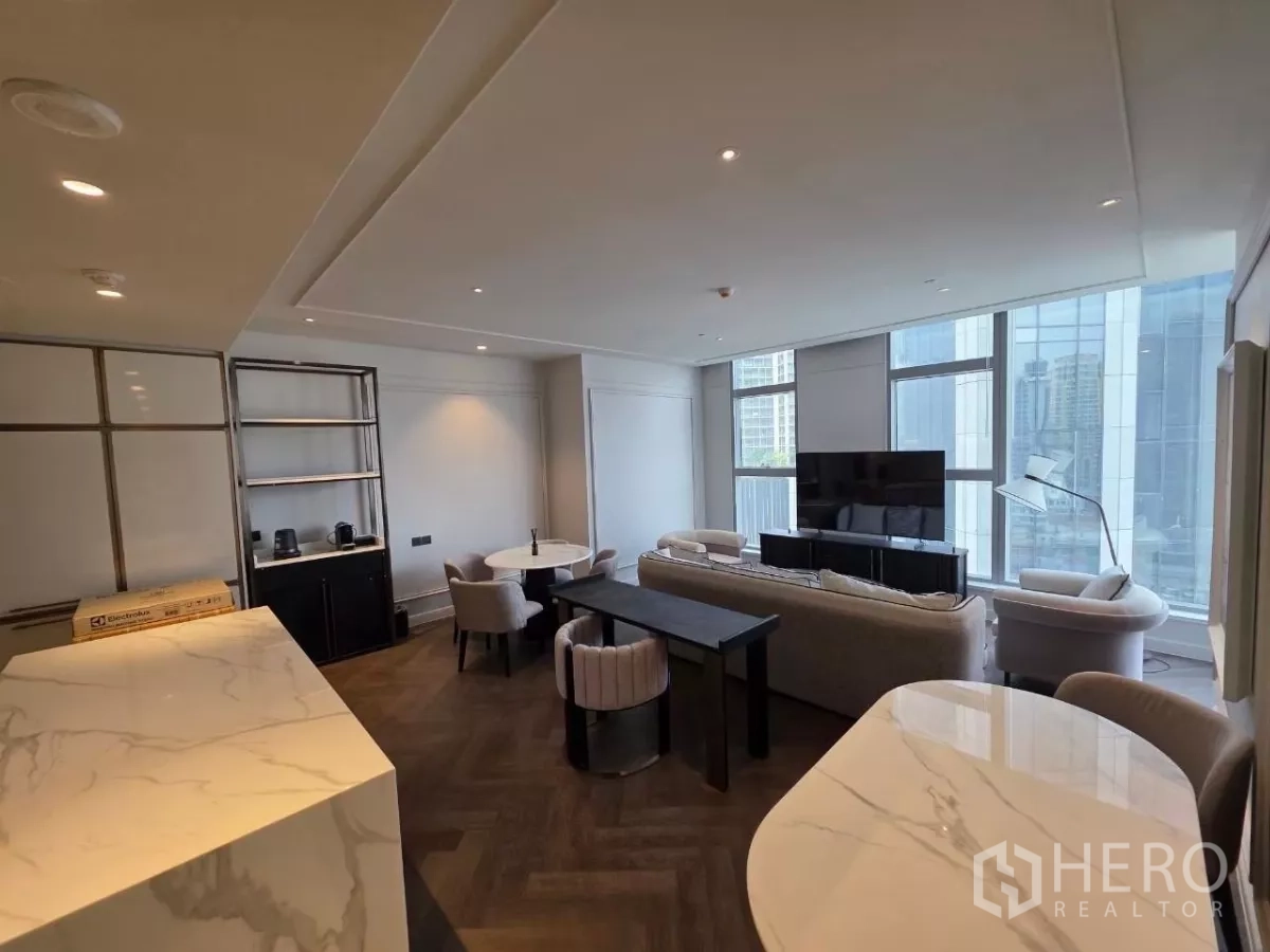 Condominium for rent - Open-plan living seen from the kitchen with herringbone floor and expansive windows.