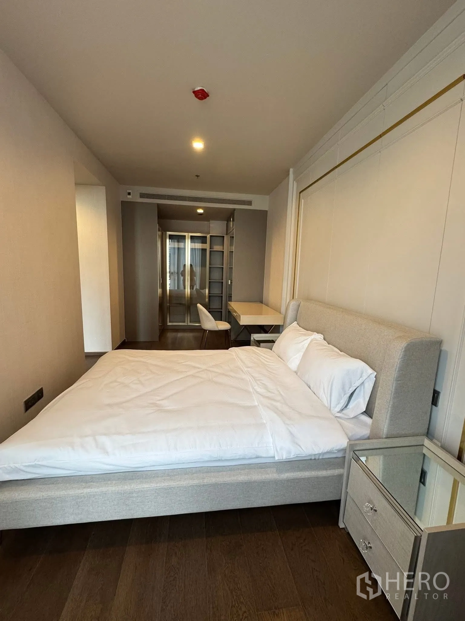 Condominium for rent in Khlong Toei, Bangkok - Bedroom angle showing desk and wardrobe leading to the living area.