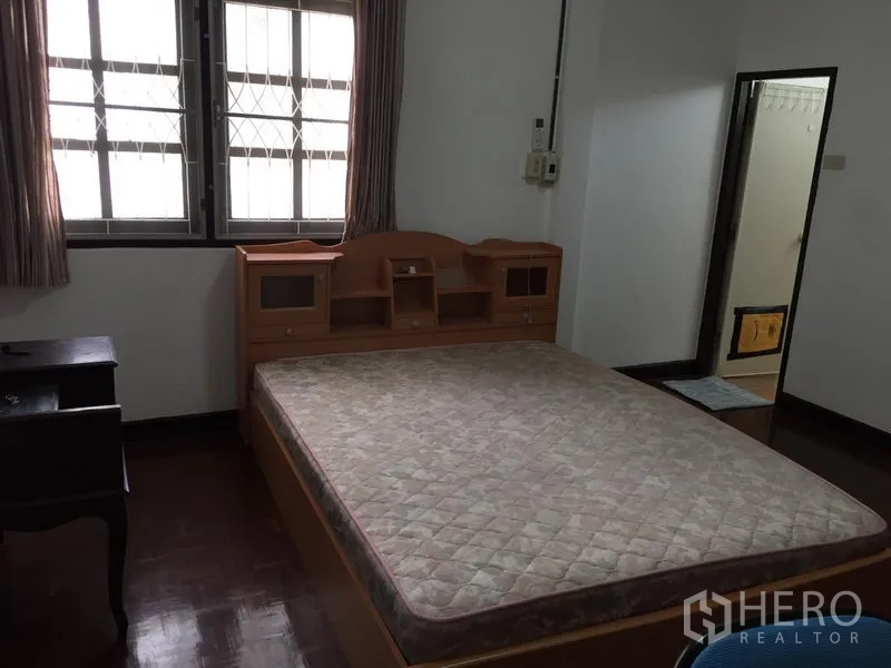 联排别墅 出租在Phra Khanong, Bangkok - 主卧配大床，窗户带防护栏，带套内卫生间入口。