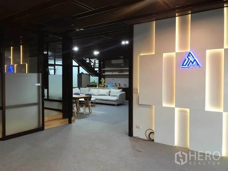 Office Space for rent in Bang Na, Bangkok - Reception area showcasing backlit feature wall, frosted partitions and view to lounge.