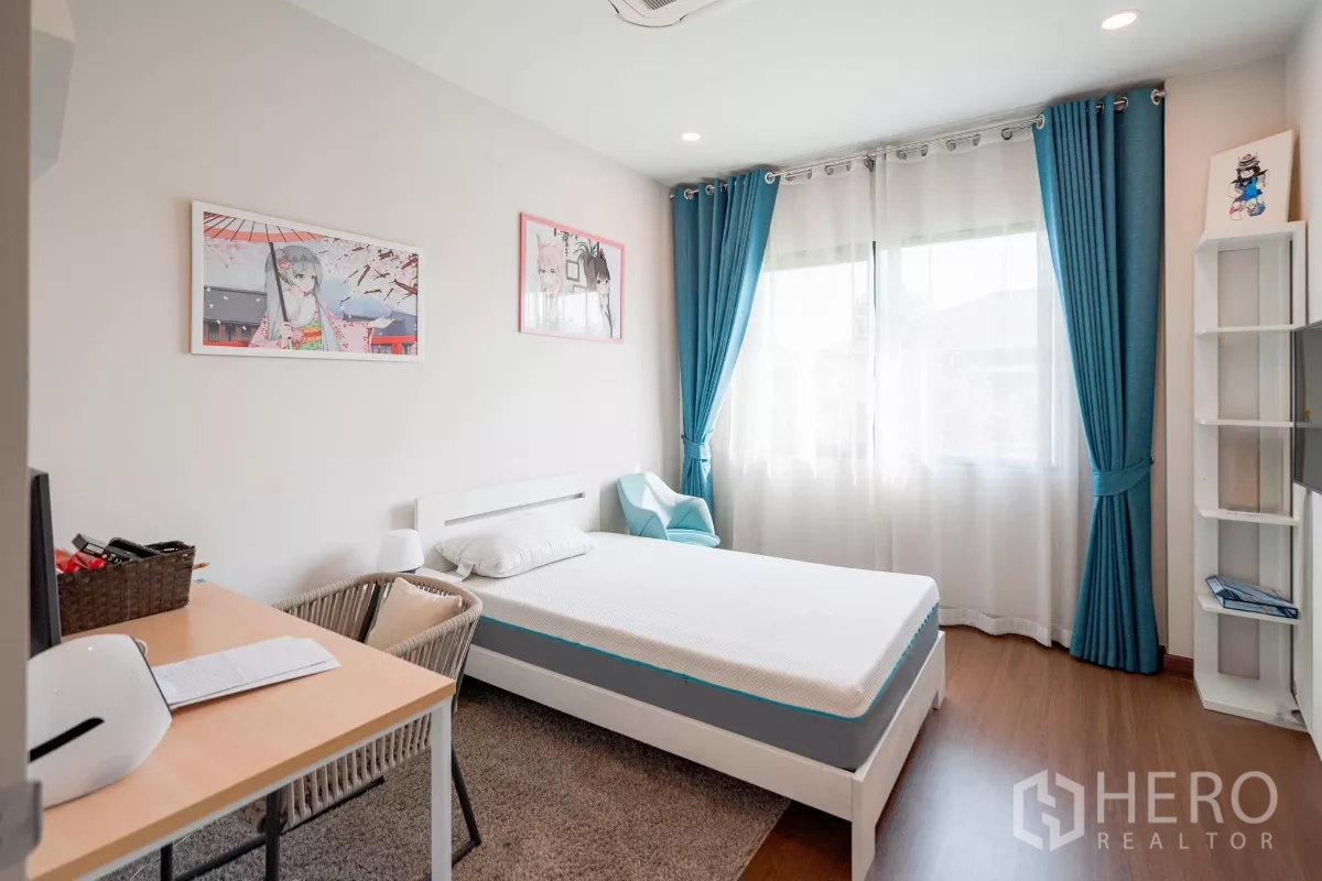 Detached House for sale in Saphan Sung, Bangkok - Bright bedroom with a single bed, study desk and large window with teal curtains.