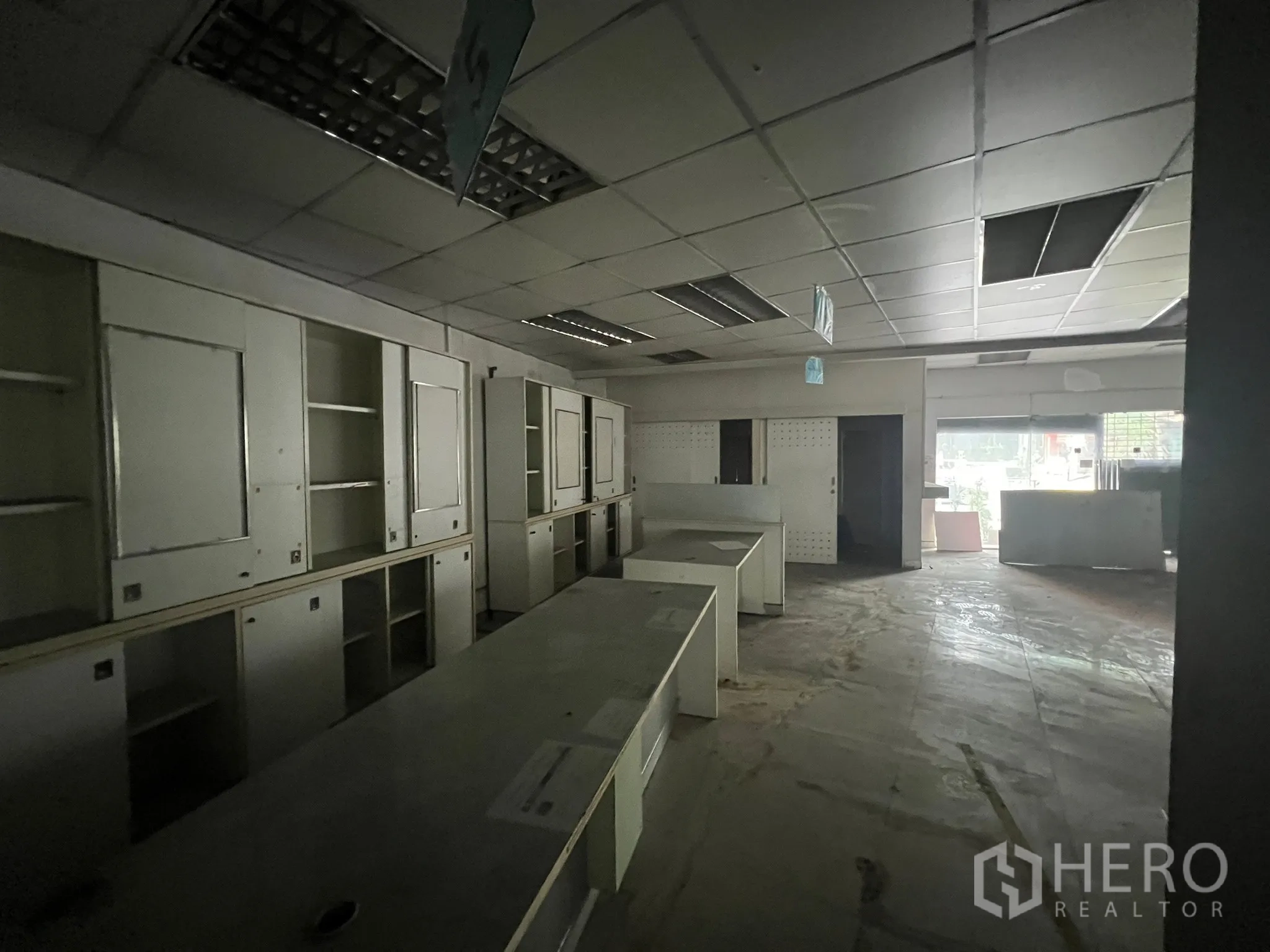 Shophouse for rent or sale in Khlong Toei, Bangkok - Back office area fitted with built-in cabinets and long workstations.