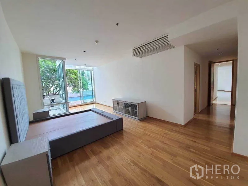 Condominium for rent or sale in Sathon, Bangkok - Spacious open-plan living and dining area with floor-to-ceiling windows and pool view.