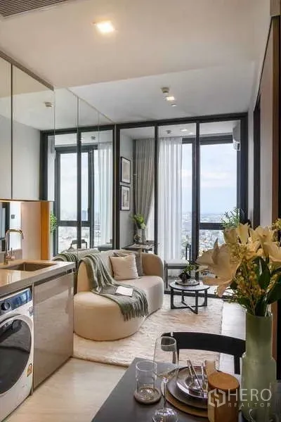 Condominium for rent in Chatuchak, Bangkok - View from dining and kitchen toward the living room and balcony with broad city panorama.