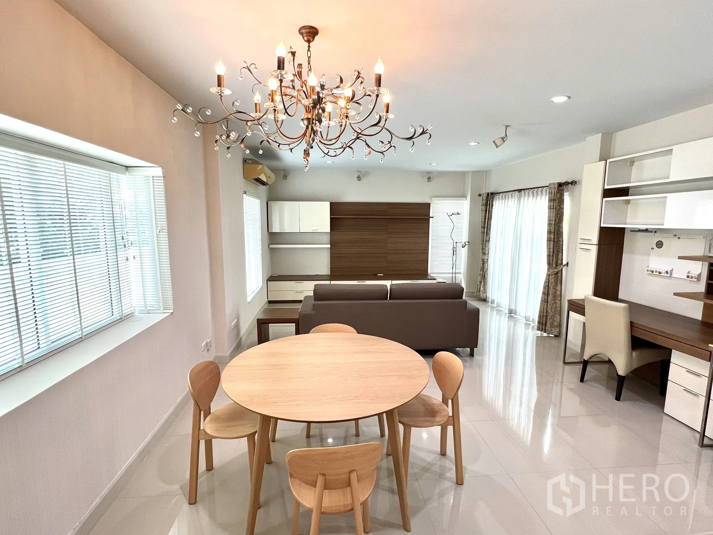 独立式住宅 出租或出售在Saphan Sung, Bangkok - 明亮开放式客餐厅，水晶吊灯、沙发与内置柜。