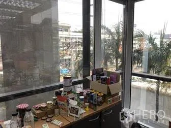 Office Space for rent in Khlong Toei, Bangkok - Corner windows showing city views with a countertop for office supplies.