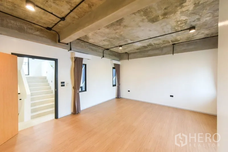 Home Office for rent or sale - Large flexible room with industrial ceiling and warm wood floors.