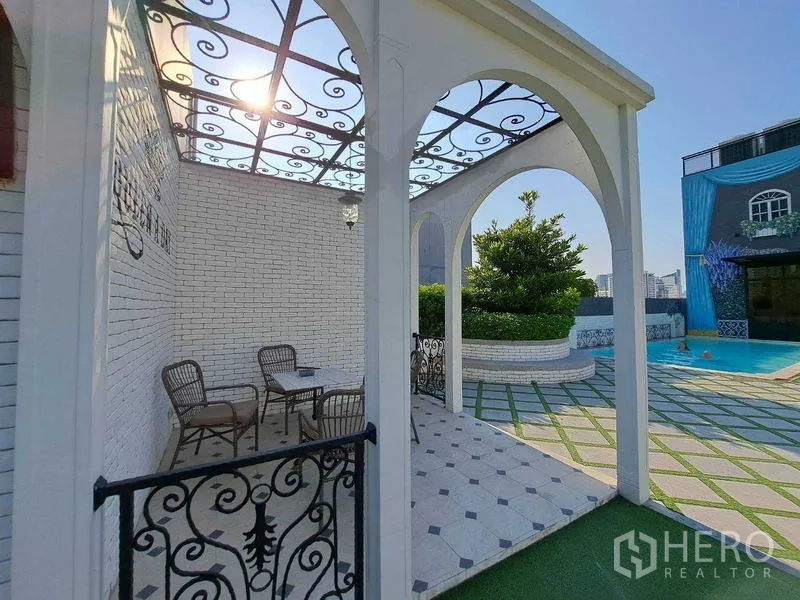 Retail Space for rent in Watthana, Bangkok - Gazebo with arched trellis and tiled patio facing landscaped courtyard and pool.