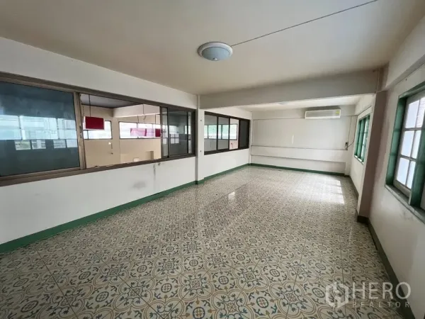 Detached House for rent in Suan Luang, Bangkok - Upstairs room with patterned floor tiles and windows on two sides.