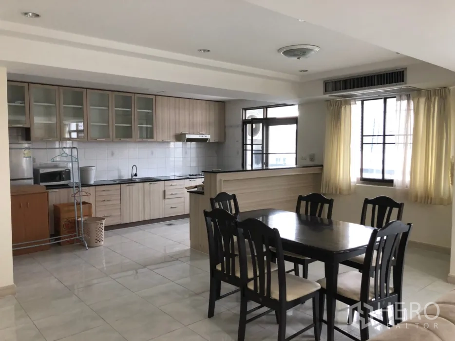 Condominium for rent in Watthana, Bangkok - Repeat view: dining area beside the kitchen with six chairs.