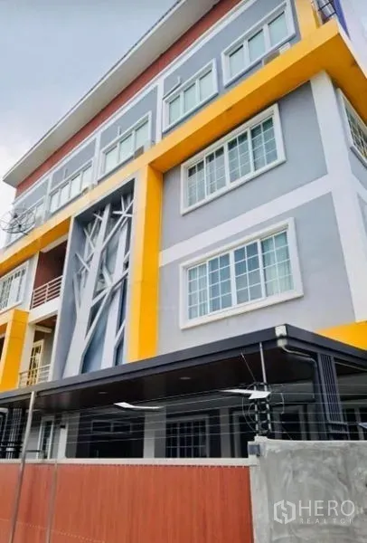Home Office for rent or sale in Pak Kret, Nonthaburi - Colorful home office exterior with large grid windows and a front canopy.