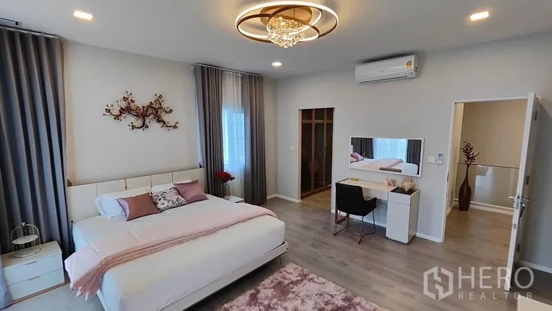 Detached House for rent in Prawet, Bangkok - Master bedroom view showing vanity desk and walk-in closet entrance.
