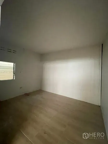 Factory for rent in Lat Lum Kaeo, Pathum Thani - Empty white room with a small window and wood-look flooring.