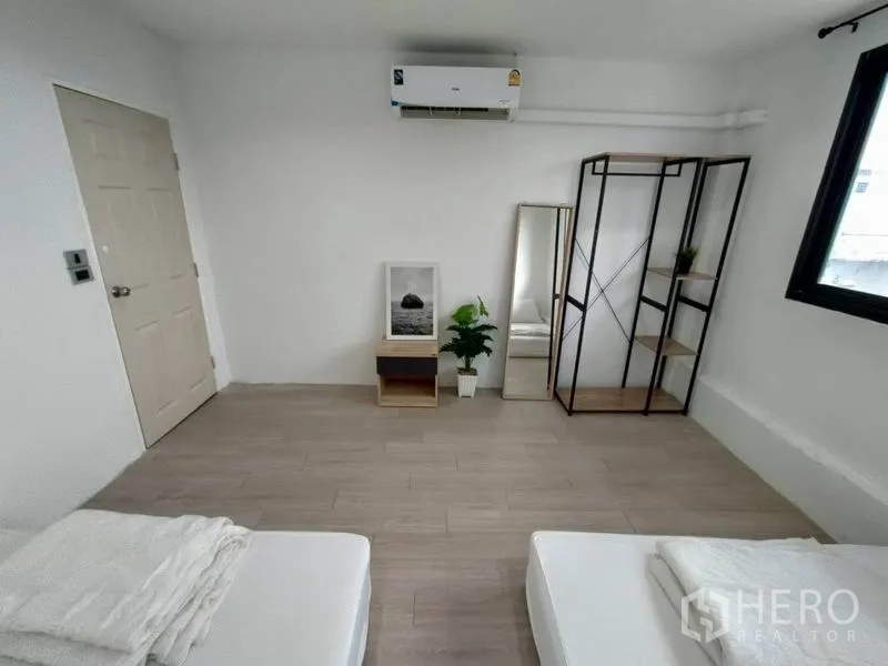 Home Office for rent - Bedroom featuring open metal shelving, full-height mirror, air conditioner and window.