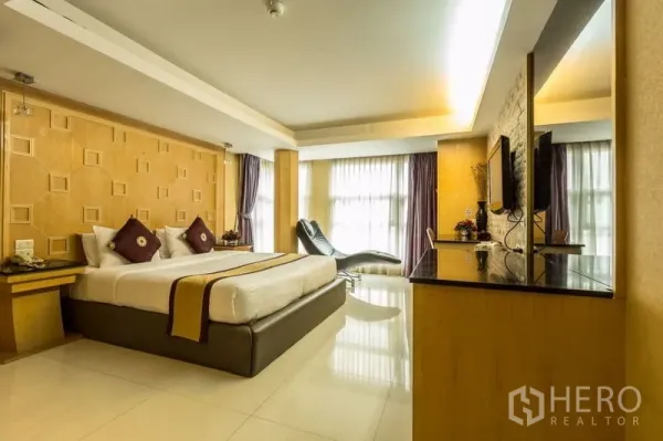 Retail Space for rent - Spacious guest-style room with a king bed, large windows and built-in cabinetry.